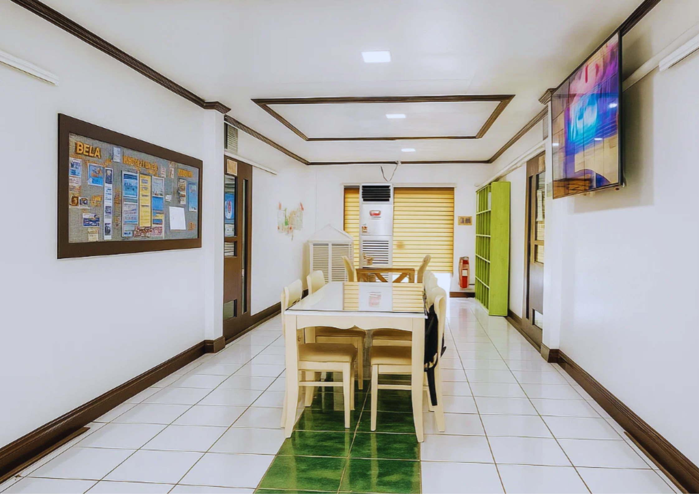 Lobby of BELA E4U Academy located inside the main building. It is designed with chairs, tables, and books to support students who wants to read or write homeworks. There is also a bulletin board and a huge tv that displays the school.