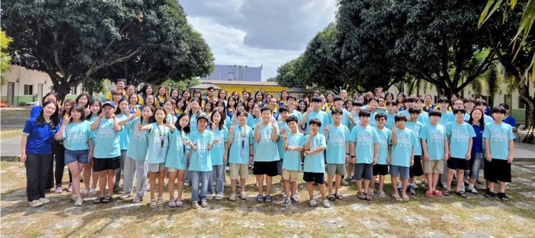 community - BELA E4U Academy students group photo on outdoors with their teachers and student managers.